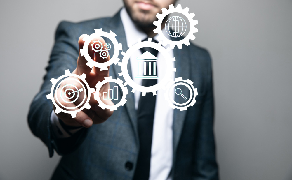 Automatic Business Management. Icons in Gears. Businessman Holds in Hand