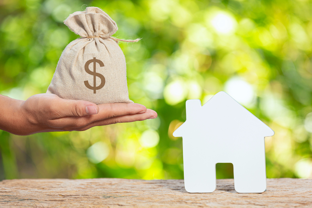 World Habitat Day,Close up Picture of a Sack of Coins and a Model House