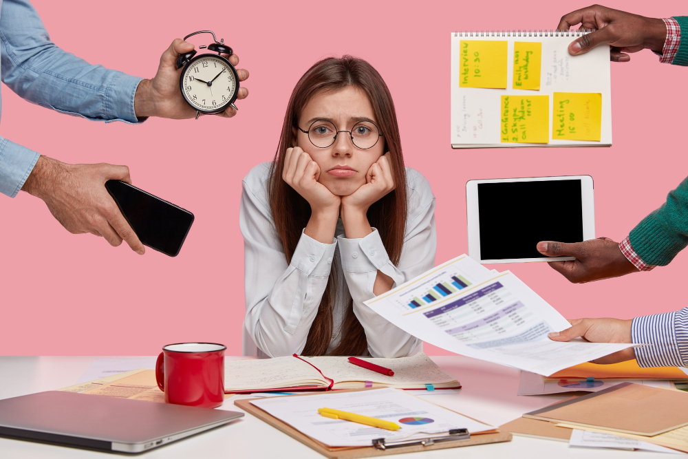 Sad Female Workaholic Keeps Hands Under Chin