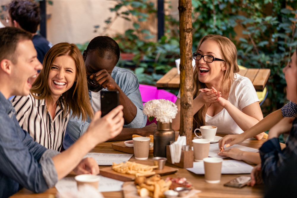 Sincere Laugh and Showing Picture on the Smartphone