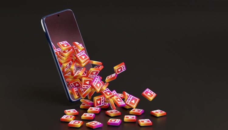 Many Instagram Reels Logos Coming Out of a Mobile Phone