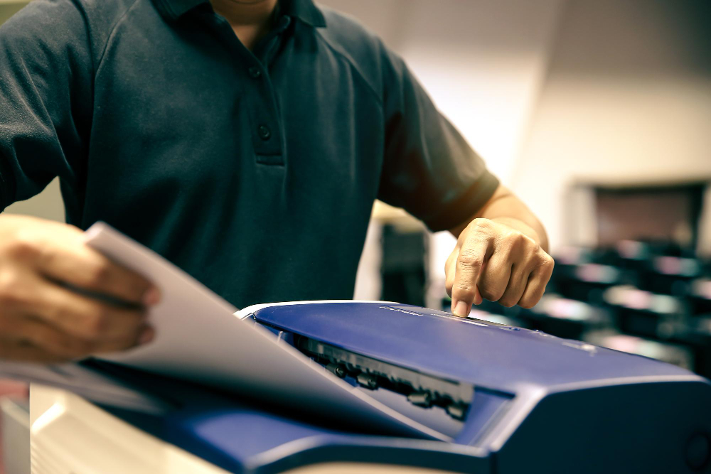 Technician Hand Press Button and Load Paper in Tray To Using Photocopier 