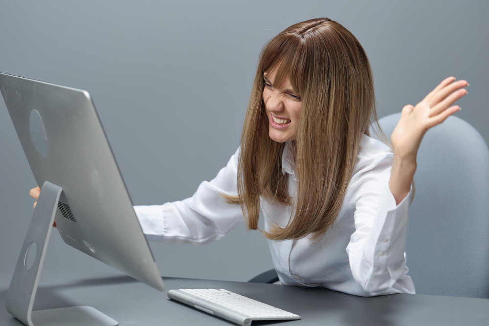 Angry Evil Pretty Blonde Businesswoman Worker Screaming to Desktop 