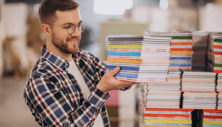 Man Working In Printing House With Paper and Paints