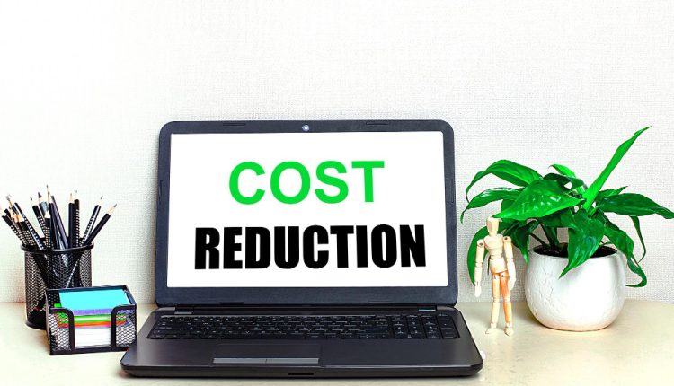 open laptop with the text cost reduction on the screen